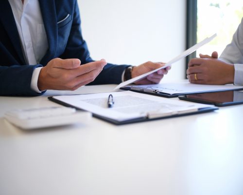 Sales Manager Giving Advice Application Form Document, Considering Mortgage Loan Offer For Car And House Insurance.