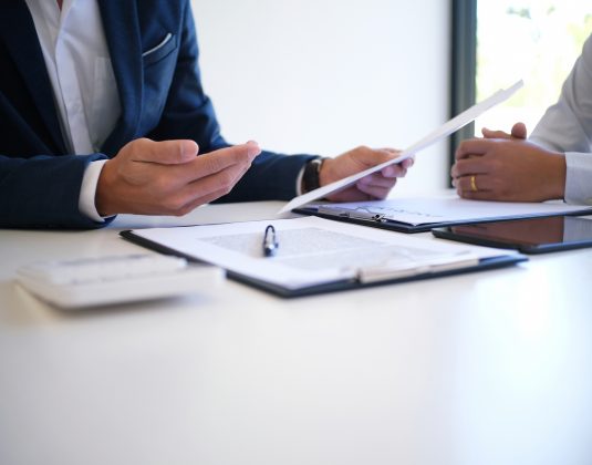 Sales Manager Giving Advice Application Form Document, Considering Mortgage Loan Offer For Car And House Insurance.